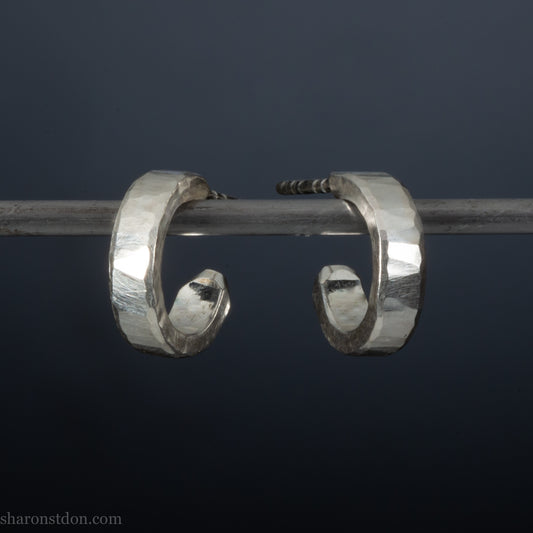 A close-up view of handcrafted solid silver hoop earrings, 12mm diameter x 3mm wide x 1.5mm thick with a hammered matte finish.