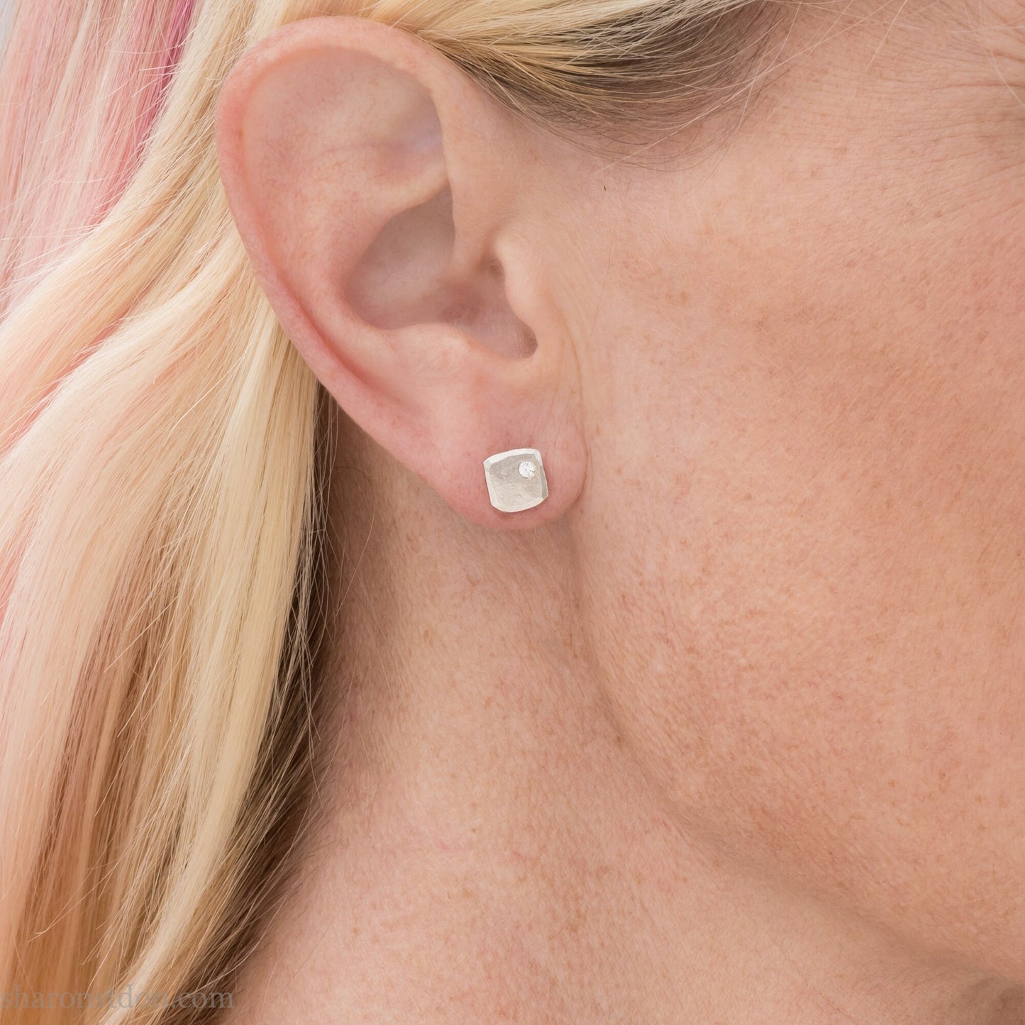 7mm square 925 sterling silver stud earrings with a 2 millimeter Canadian diamond gemstone in the corner. Hammered texture with a matte, shiny finish. Handmade by Sharon SaintDon in North America.