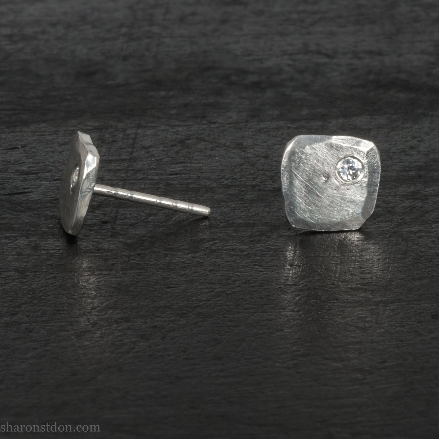 7mm square 925 sterling silver stud earrings with a 2 millimeter Canadian diamond gemstone in the corner. Hammered texture with a matte, shiny finish. Handmade by Sharon SaintDon in North America.