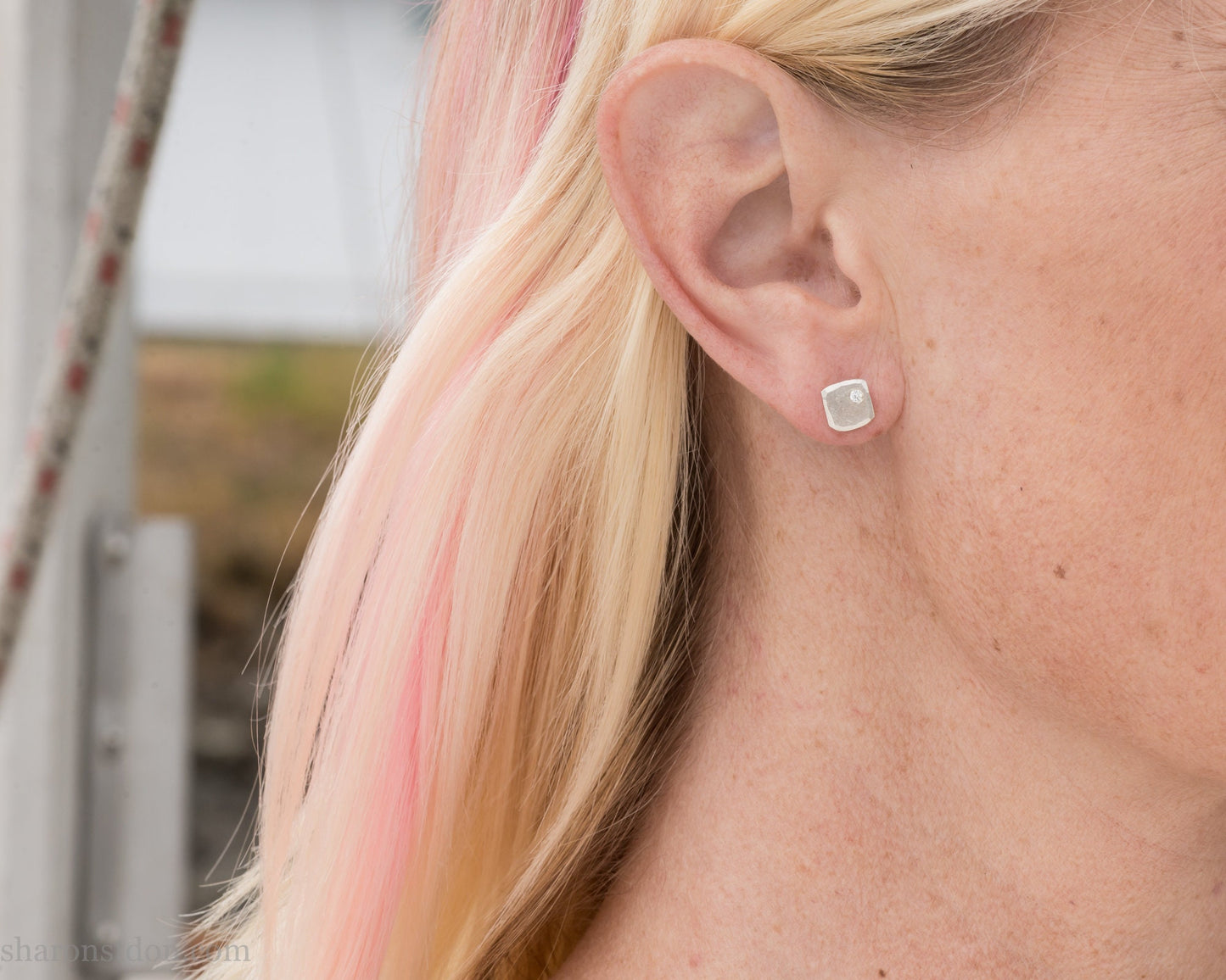 7mm square 925 sterling silver stud earrings with a 2 millimeter Canadian diamond gemstone in the corner. Hammered texture with a matte, shiny finish. Handmade by Sharon SaintDon in North America.