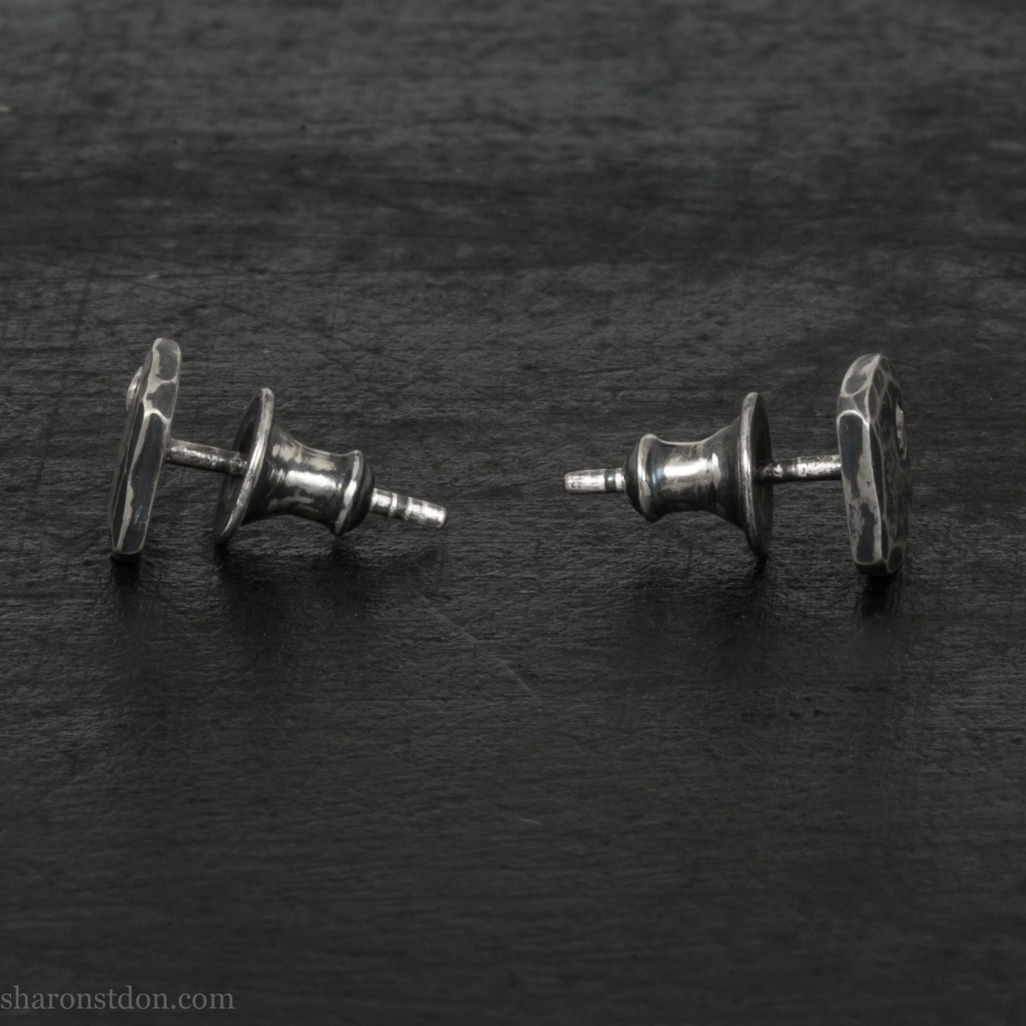 Small 925 sterling silver stud earrings for men with 2mm, imitation diamond gemstone set in the corner. 7mm square, 1.5mm thick with silver posts and backs and hammered, dark, antiqued finish. Handmade by Sharon SaintDon in North America.