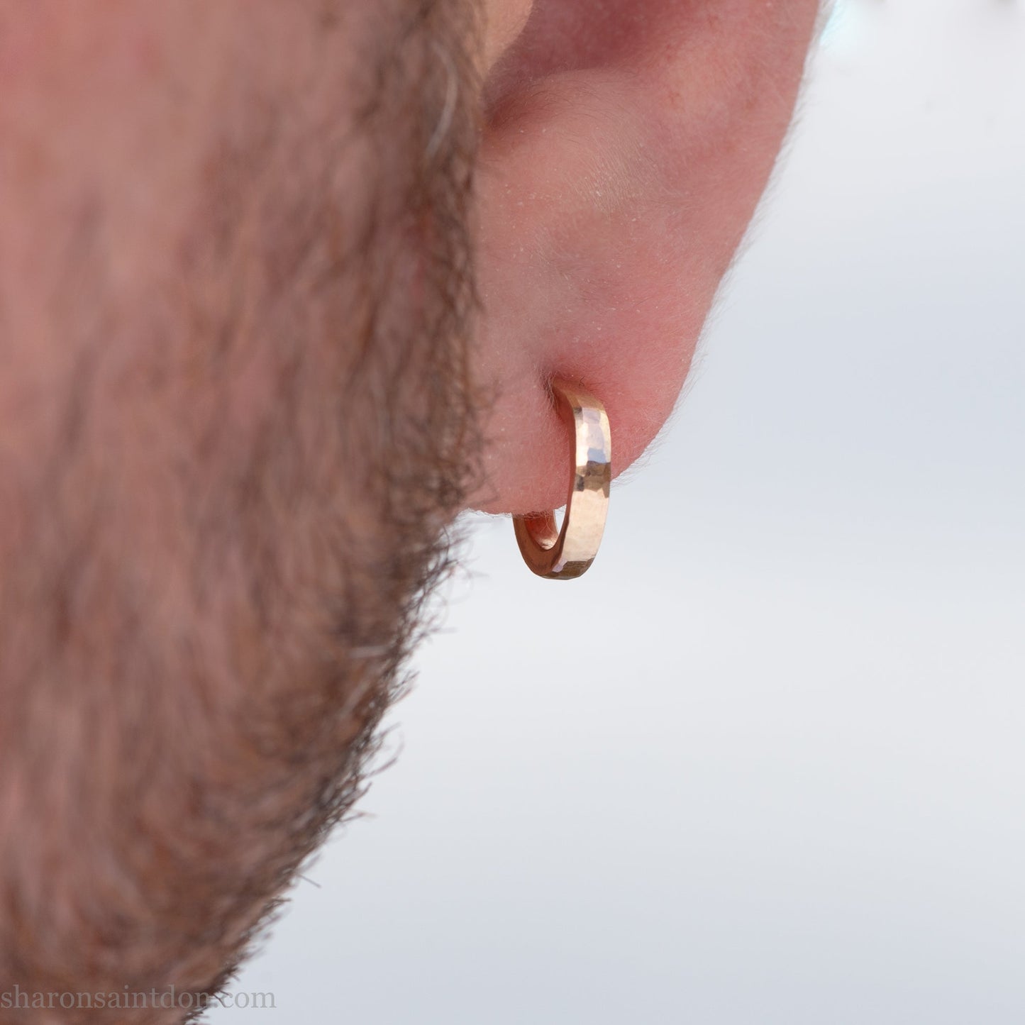 12mm x 2mm solid 18k gold hoop earrings for men. Exterior diameter 12mm, Interior diameter 9mm. Handmade by Sharon SaintDon in North America. Hammered, solid, real gold with gold posts.