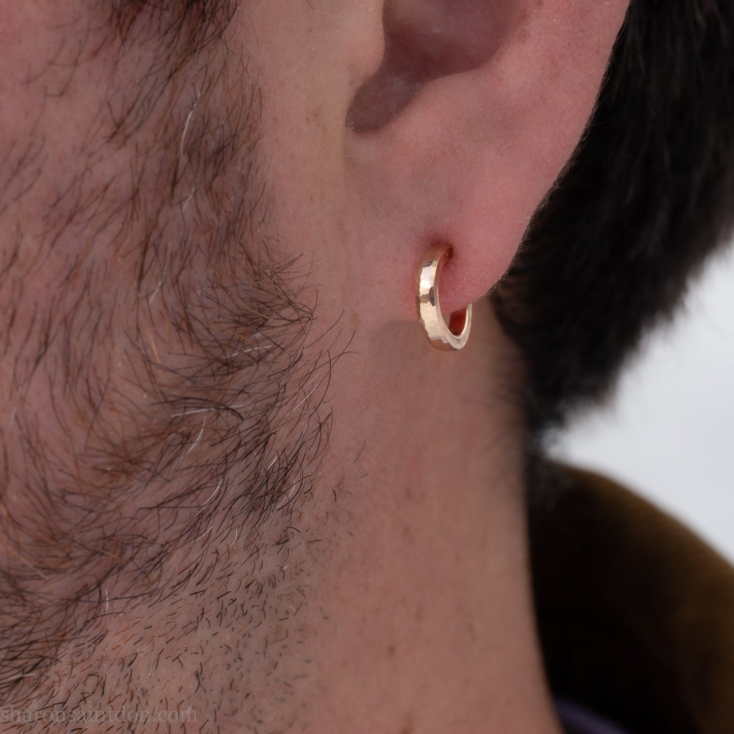 12mm x 2mm solid 18k gold hoop earrings for men. Exterior diameter 12mm, Interior diameter 9mm. Handmade by Sharon SaintDon in North America. Hammered, solid, real gold with gold posts.