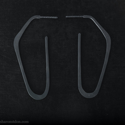 Hand hammered solid 925 sterling silver hoop earrings. Long, angular, high D shape, oxidized black, 47mm high x 19mm wide.