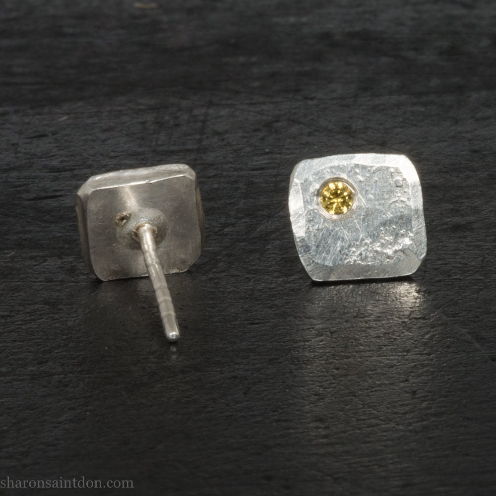 925 sterling silver square stud earrings with lab grown golden yellow topaz gemstones. 925 sterling silver handmade by Sharon SaintDon in North America. 7mm x 7mm, 1.5 thick with 2mm round flush set stone in corner. Silver posts and backs.