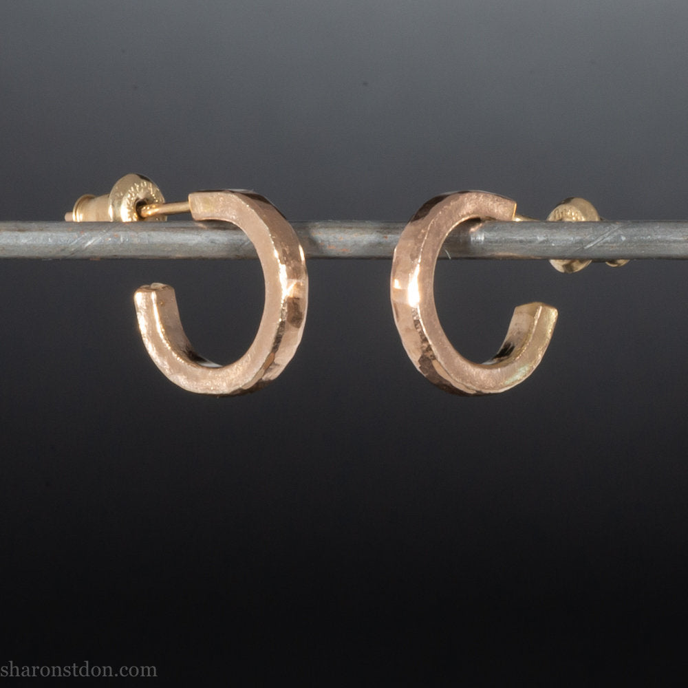 12mm x 2mm solid 18k gold hoop earrings for men. Exterior diameter 12mm, Interior diameter 9mm. Handmade by Sharon SaintDon in North America. Hammered, solid, real gold with gold posts.