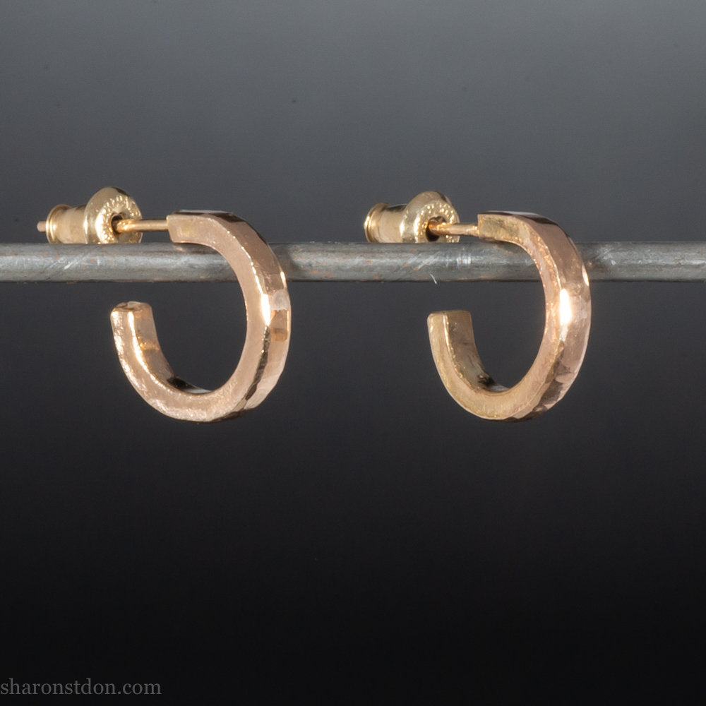 12mm x 2mm solid 18k gold hoop earrings for men. Exterior diameter 12mm, Interior diameter 9mm. Handmade by Sharon SaintDon in North America. Hammered, solid, real gold with gold posts.