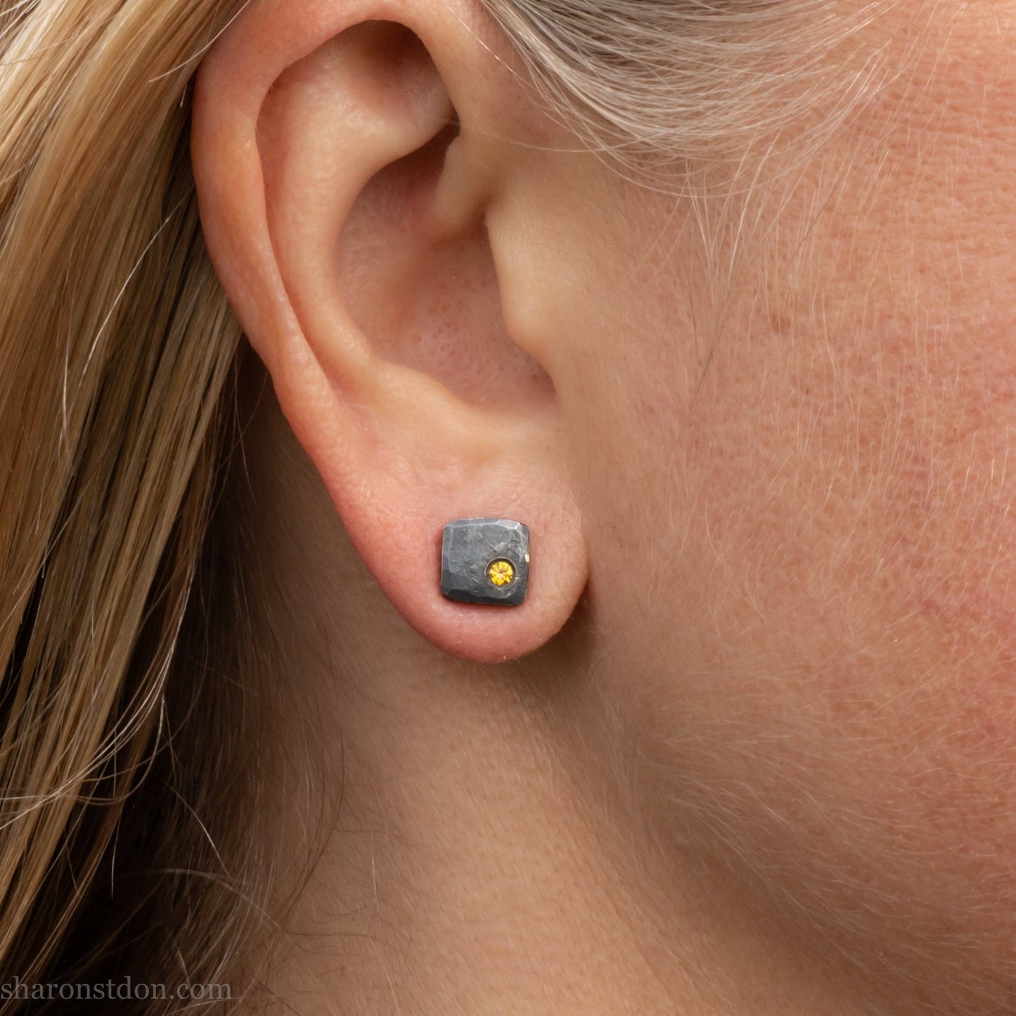 Handmade 925 sterling silver stud earrings handmade by Sharon SaintDon In North America. 7mm x 7mm hammered, square, oxidized black silver with a 2mm round lab grown golden yellow topaz gemstone in the corner.