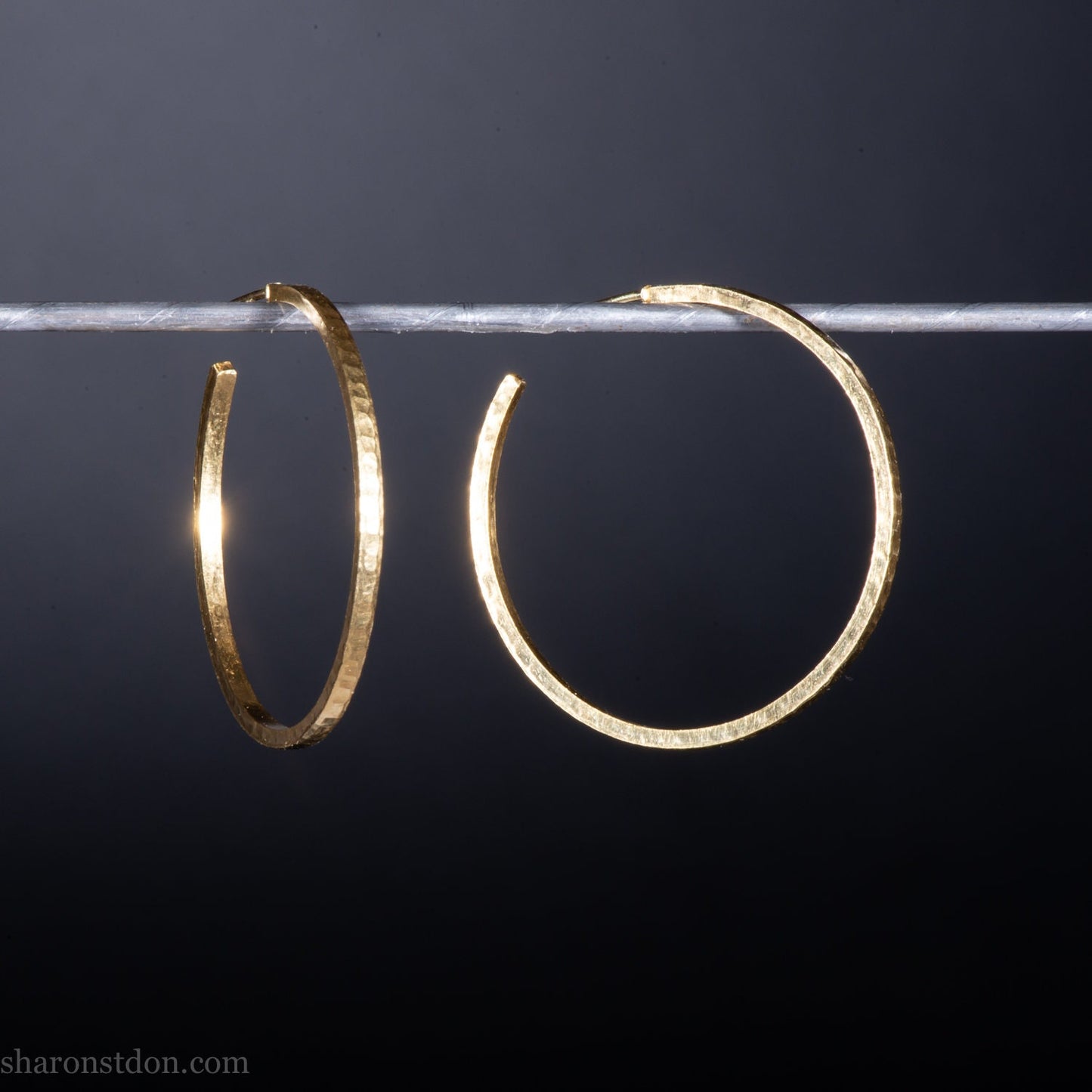 40mm diameter by 1.5mm thick handmade solid 18k yellow gold hoop earrings. Handmade by Sharon SaintDon in North America. Hammered from solid gold with a matte finish.