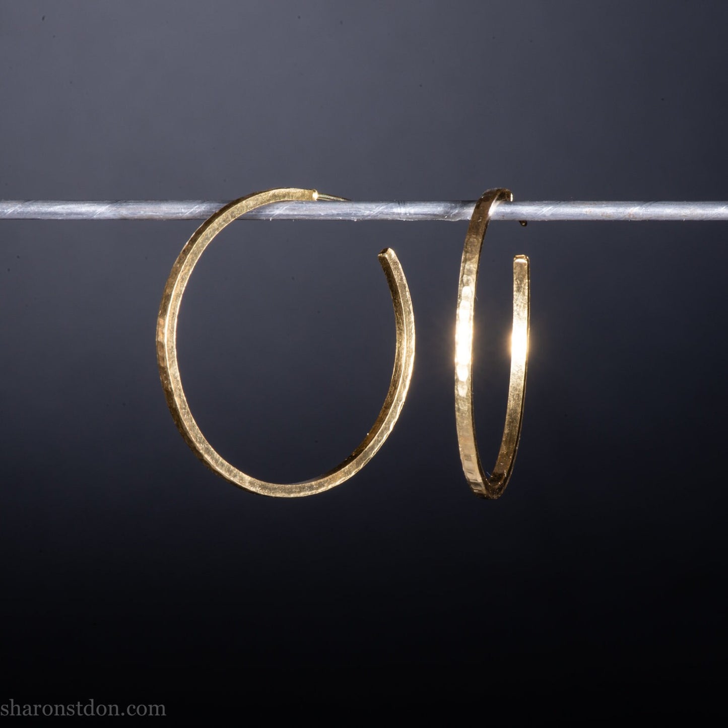 40mm diameter by 1.5mm thick handmade solid 18k yellow gold hoop earrings. Handmade by Sharon SaintDon in North America. Hammered from solid gold with a matte finish.