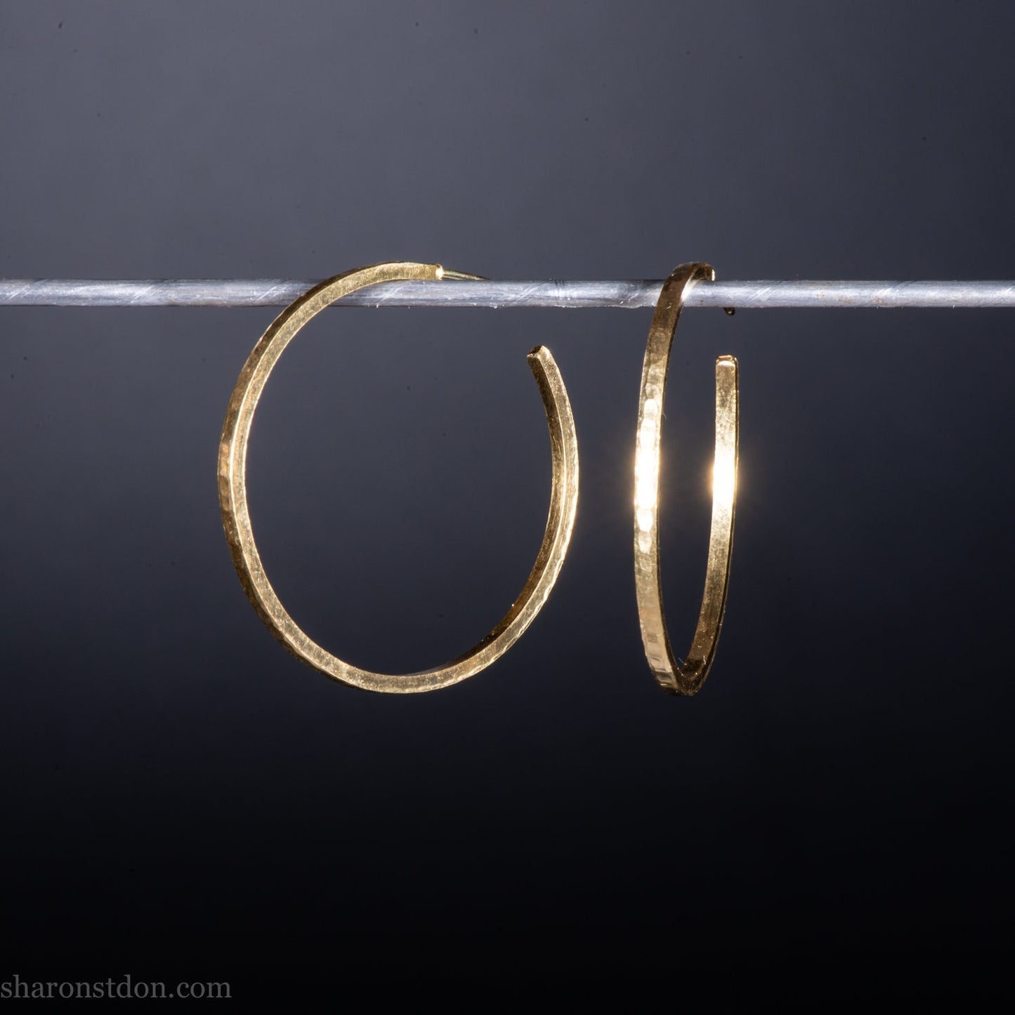 40mm diameter by 1.5mm thick handmade solid 14k yellow gold hoop earrings. Handmade by Sharon SaintDon in North America. Hammered from solid gold with a matte finish.