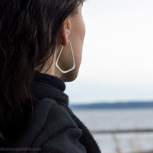 925 sterling silver hoop earrings for women. Comfortable, lightweight, daily wear earrings with a hammered texture. Size is 5cm high x 32mm wide, long teardrop shape. Solid silver backs and posts, and a matte shiny finish. Handmade in the USA.