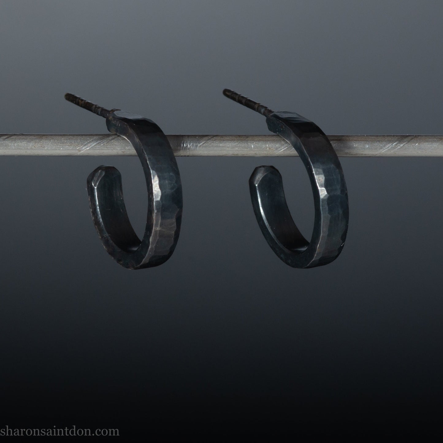 Handmade 925 sterling silver hoop earrings for men or women. 18mm x 3mm, round, oxidized black earrings with hammered texture, made by Sharon SaintDon in North America.