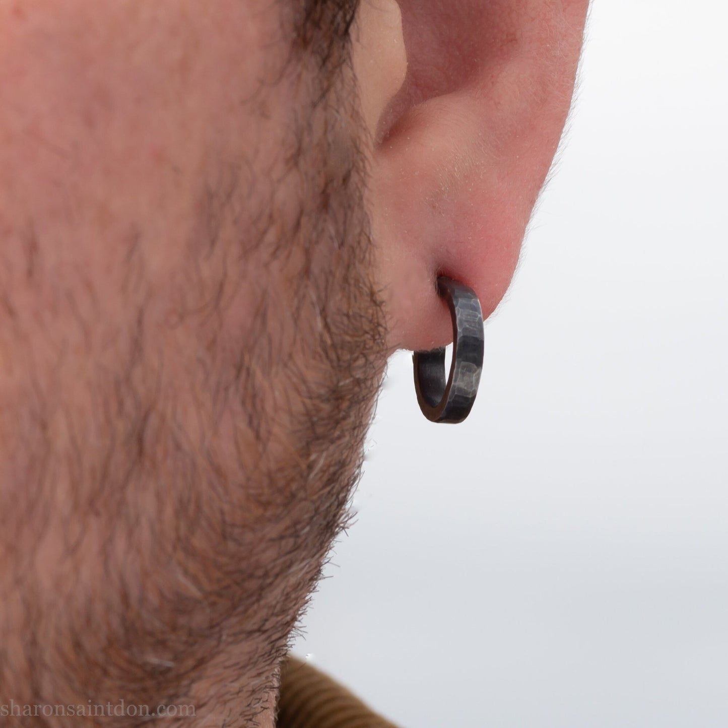 Handmade 925 sterling silver hoop earrings for men or women. 18mm x 3mm, round, oxidized black earrings with hammered texture, made by Sharon SaintDon in North America.