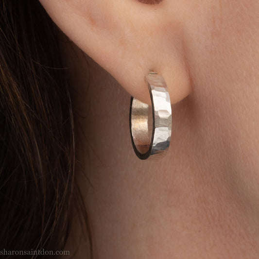 18mm x 4mm small sterling silver hoop earrings for for men or women, unisex. Handmade in North America by Sharon SaintDon. Hammered texture, solid silver with silver posts and backs.