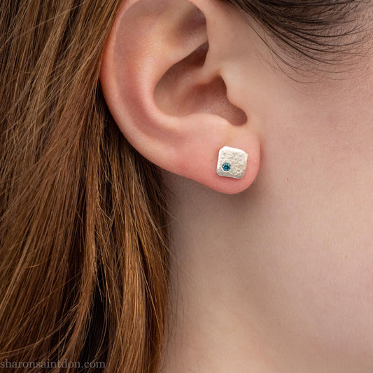 Teal blue diamond gemstone stud earrings. Solid 925 sterling silver, 7mm square with a 2mm round diamond flush set in the corner. Handmade by Sharon SaintDon in North America.