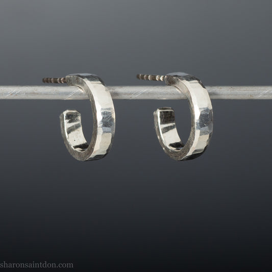 Close-up view of hand-hammered 925 sterling silver hoop earring, 14mm diameter, 3mm wide, 1.5mm thick, brushed matte satin finish.