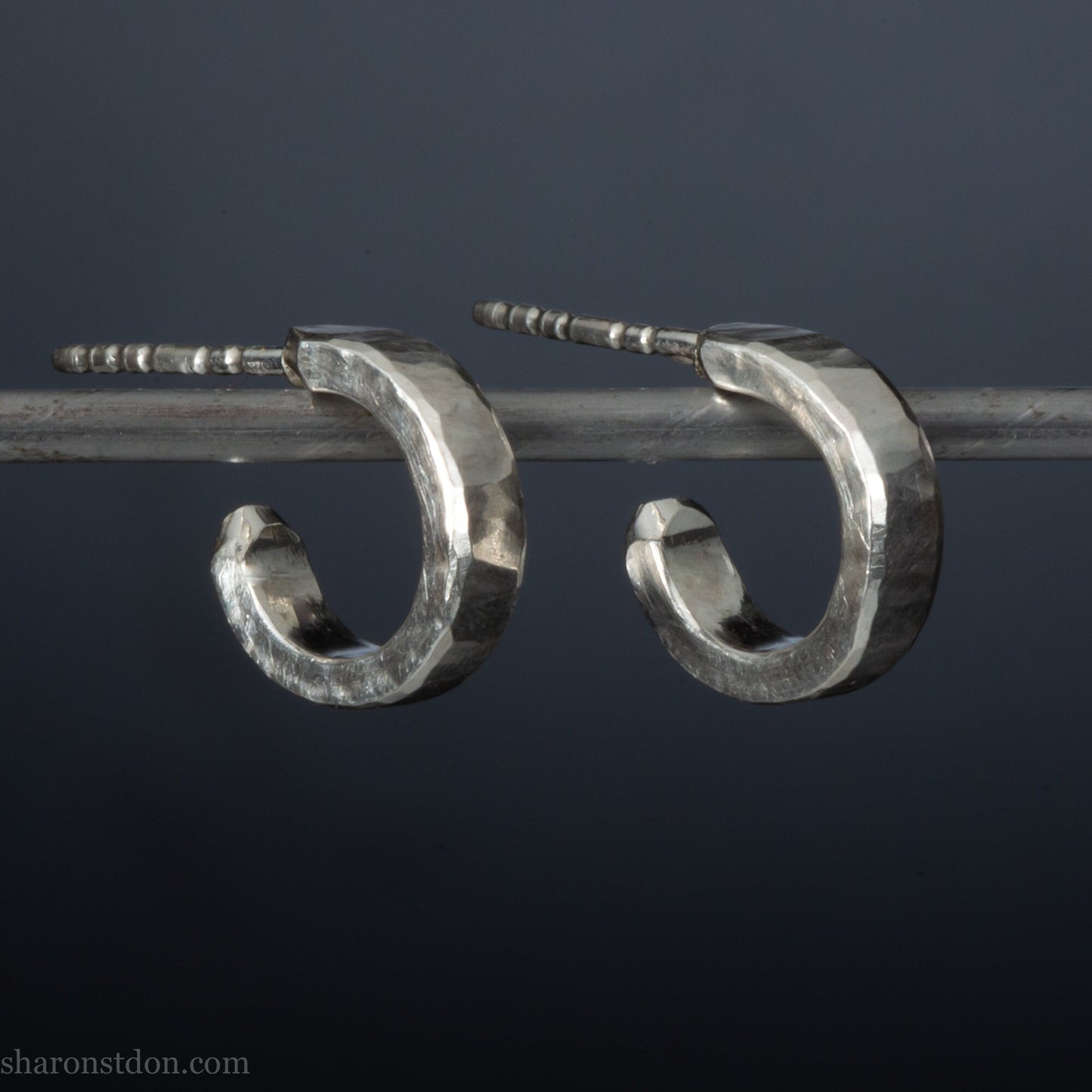 Hammered solid 925 silver hoop earrings with a matte shiny finish. 12mm exterior diameter, 9mm interior, 3mm wide and 1.5mm thick. Solid sterling silver posts and backs. Handcrafted by Sharon Saint Don in the USA.