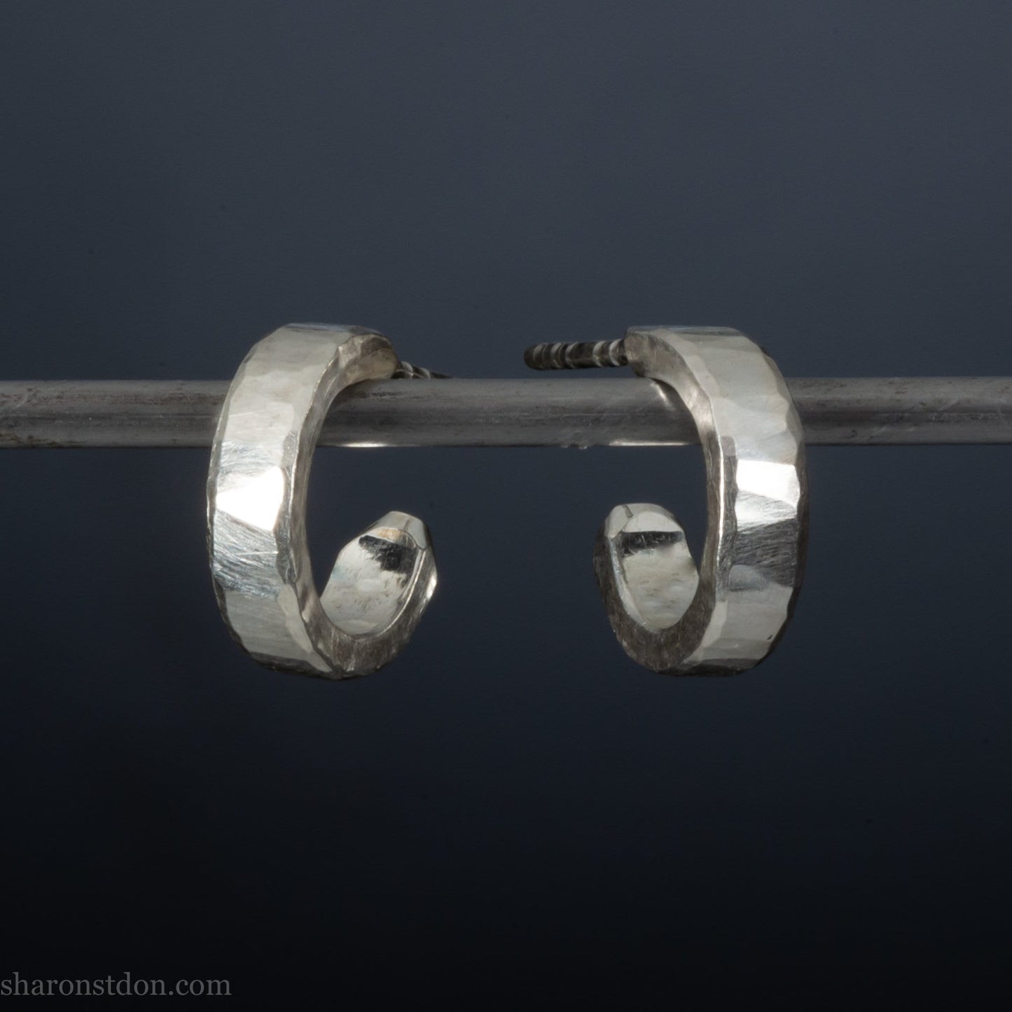 Hammered solid 925 silver hoop earrings with a matte shiny finish. 12mm exterior diameter, 9mm interior, 3mm wide and 1.5mm thick. Solid sterling silver posts and backs. Handcrafted by Sharon Saint Don in the USA.