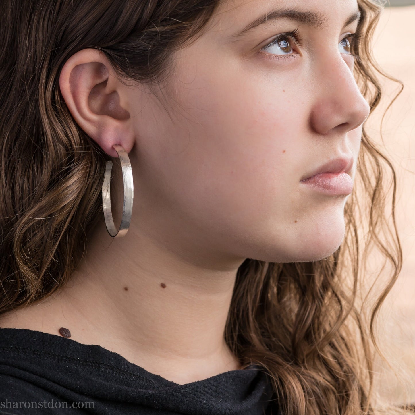 Solid large 925 sterling silver hoop earrings. Handmade by Sharon SaintDon in North America. 50mm diameter, 2mm wide, 1.5mm thick, Brushed, matte finish and silver posts and backs.