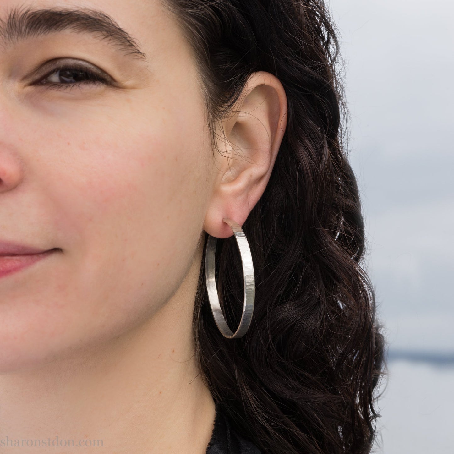 Solid 925 sterling silver hoop earrings. Handmade by Sharon SaintDon in North America. 40mm diameter, 2mm wide, 1.5mm thick, Brushed, matte finish and silver posts and backs.