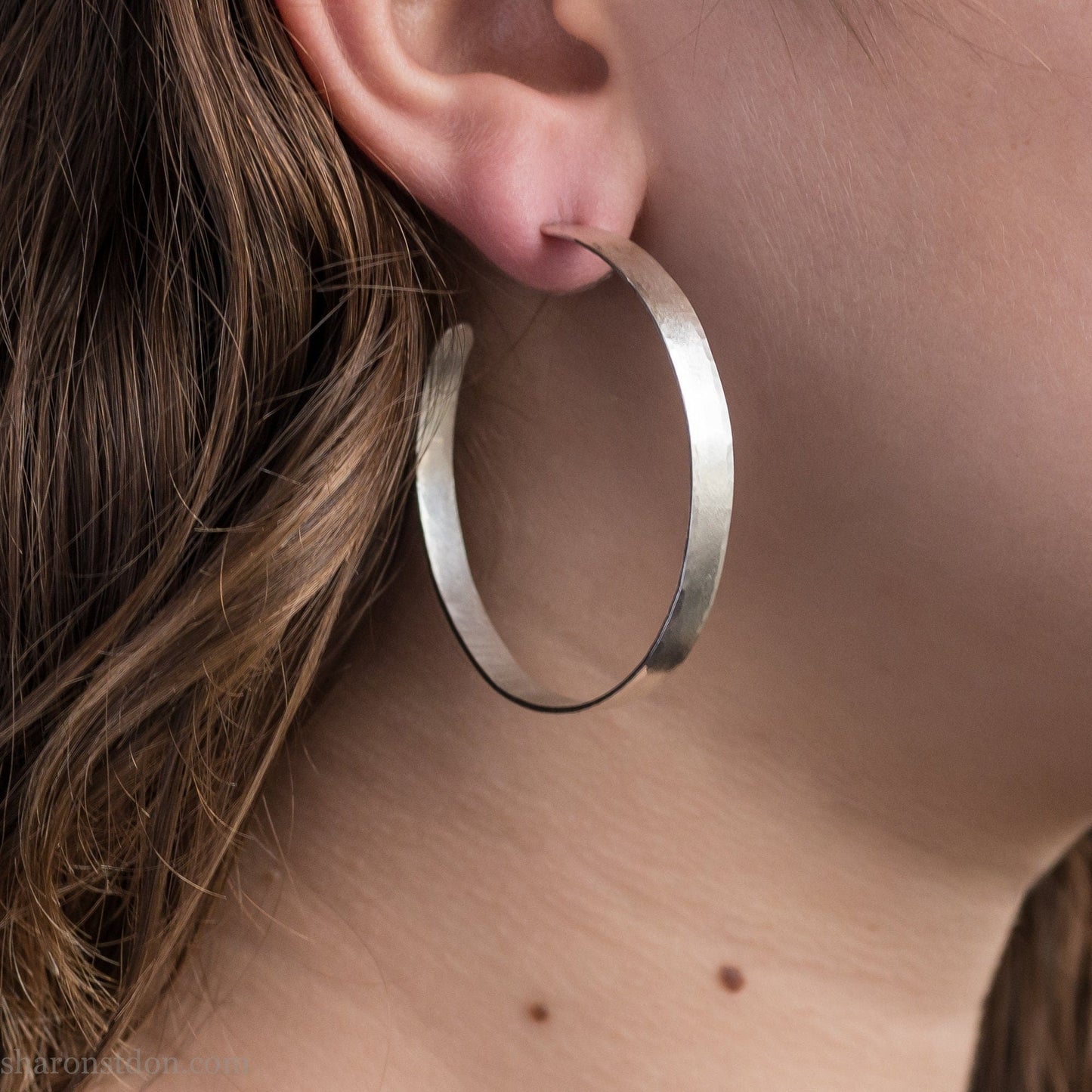 Solid 925 sterling silver hoop earrings. Handmade by Sharon SaintDon in North America. 50mm diameter, 2mm wide, 1.5mm thick, Brushed, matte finish and silver posts and backs.