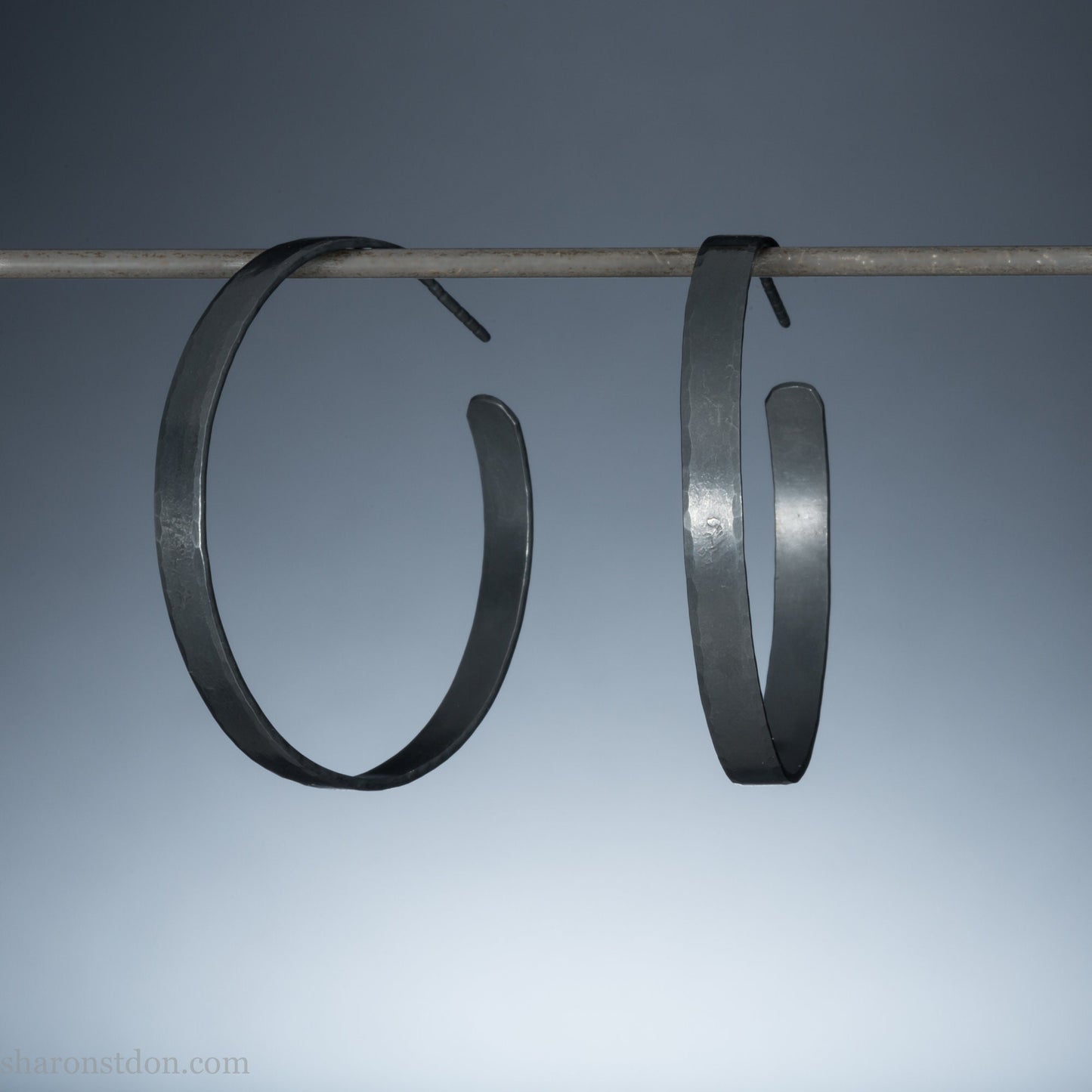 925 sterling silver hoop earrings for women. Hammered, solid silver, oxidized black with silver posts and backs. 40mm diameter, 5mm wide, .75mm thick, comfortable, lightweight. Handmade by Sharon SaintDon in Pacific Northwest, North America.