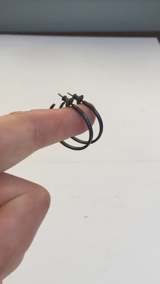 925 sterling silver hoop earrings handmade by Sharon SaintDon in the USA. 30mm diameter, 2mm wide, solid hammered silver. Oxidized black with sterling silver posts and backs.