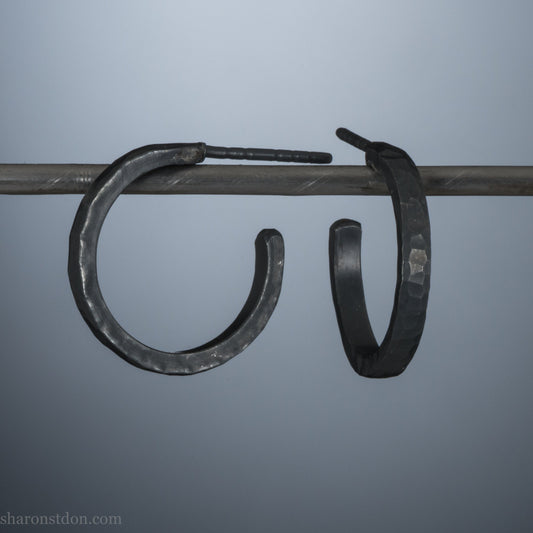 18x2mm oxidized black 925 sterling silver hammered hoop earrings, pair shown on display bar, matte dark patina.