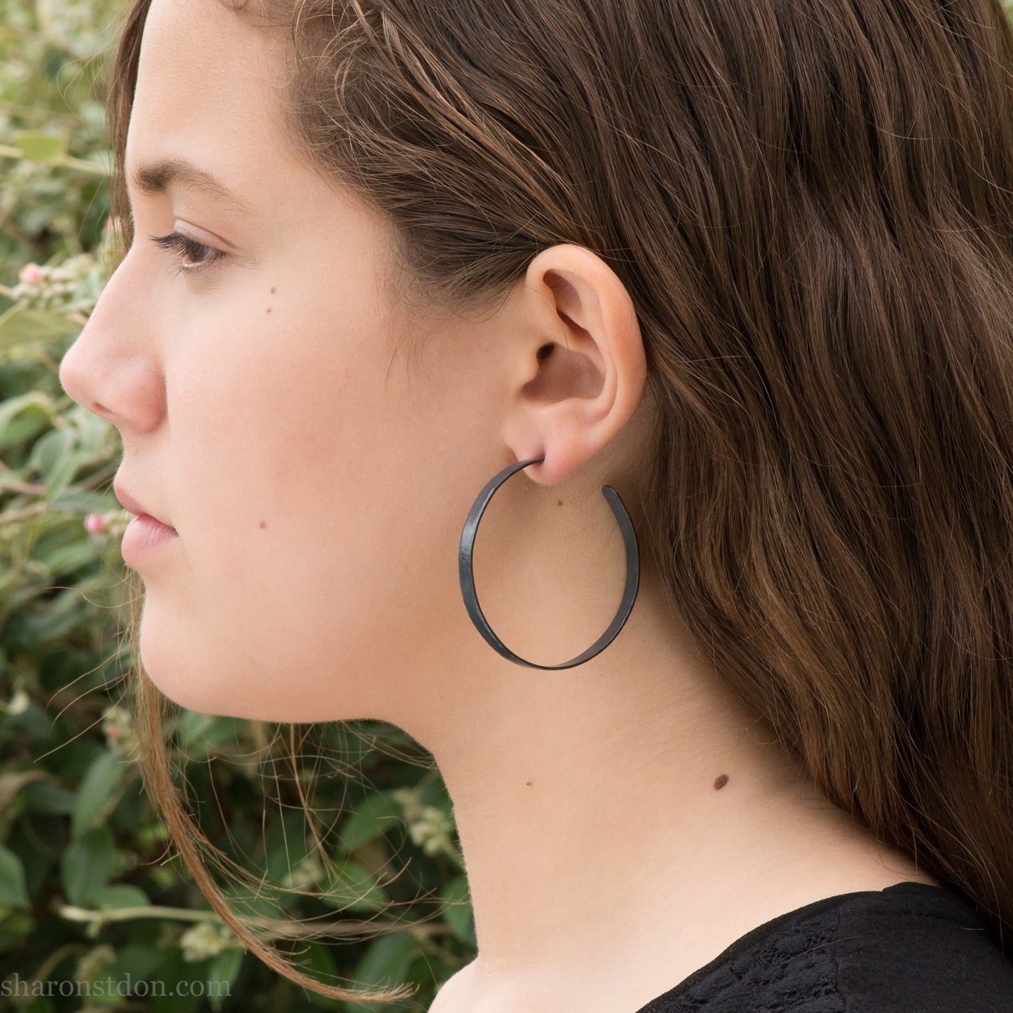 Solid 925 sterling silver hoop earrings. 50mm diameter, 5mm wide, .75mm thick. Oxidized black, charcoal grey, matte finish with silver posts and backs. lightweight, high quality, handmade by Sharon SaintDon in the Pacific Northwest of the USA.