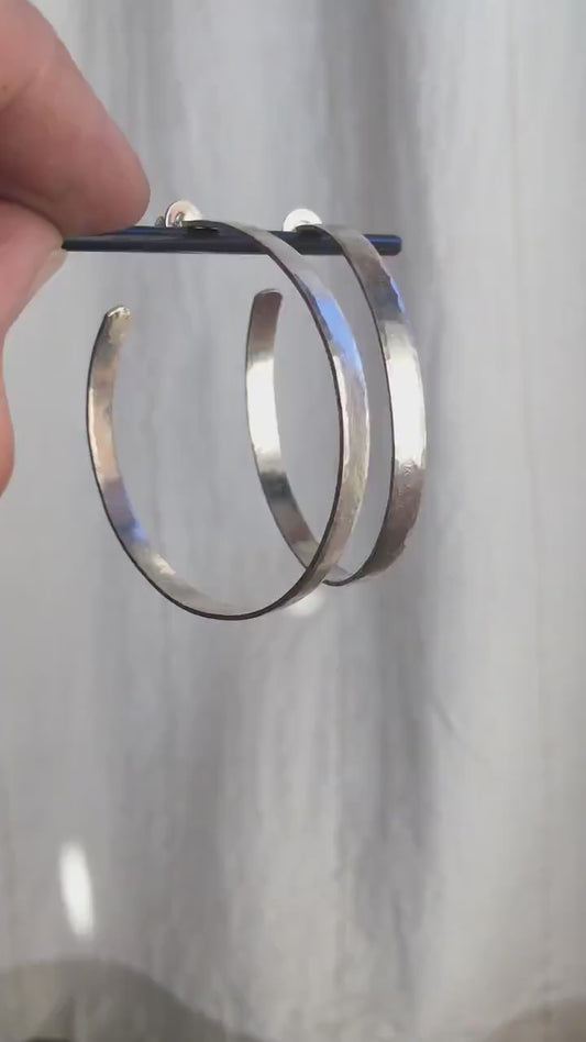 Solid 925 sterling silver hoop earrings. Handmade by Sharon SaintDon in North America. 50mm diameter, 2mm wide, 1.5mm thick, Brushed, matte finish and silver posts and backs.