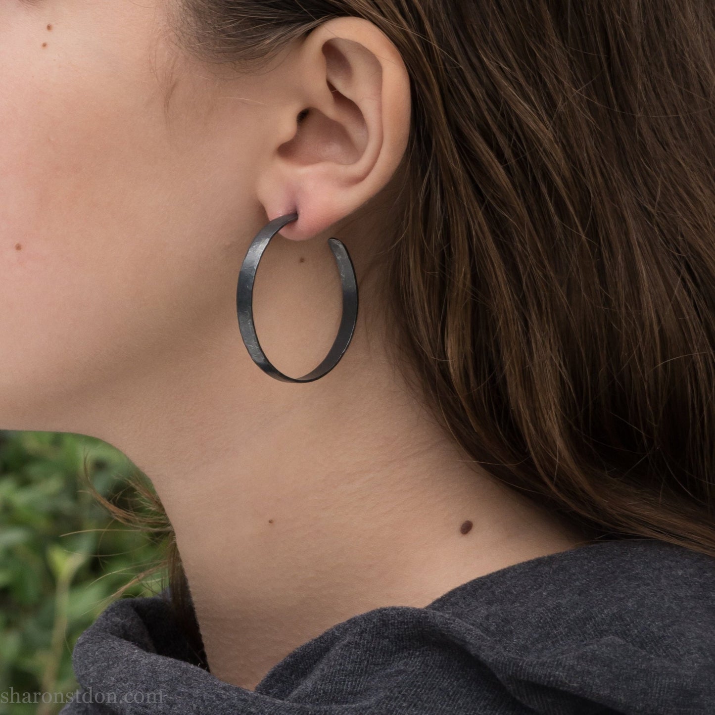 925 sterling silver hoop earrings for women. Hammered, solid silver, oxidized black with silver posts and backs. 40mm diameter, 5mm wide, .75mm thick, comfortable, lightweight. Handmade by Sharon SaintDon in Pacific Northwest, North America.