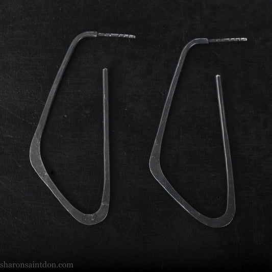 925 sterling silver hoop earrings. Long, angular, low D shape, oxidized black with hammered texture. SIZE: 5cm high x 32mm wide.