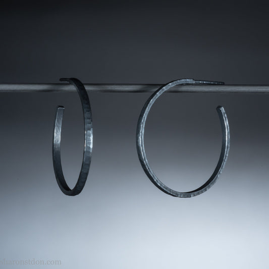 Oxidized black sterling silver hammered round hoop earrings. 30mm diameter, 2mm wide, solid hammered silver.