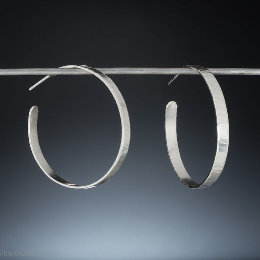 Solid 925 sterling silver hoop earrings handmade by Sharon SaintDon in the USA. 40mm diameter, 5mm wide, Matte shiny finish, hammered wavy texture, sterling silver posts and backs.