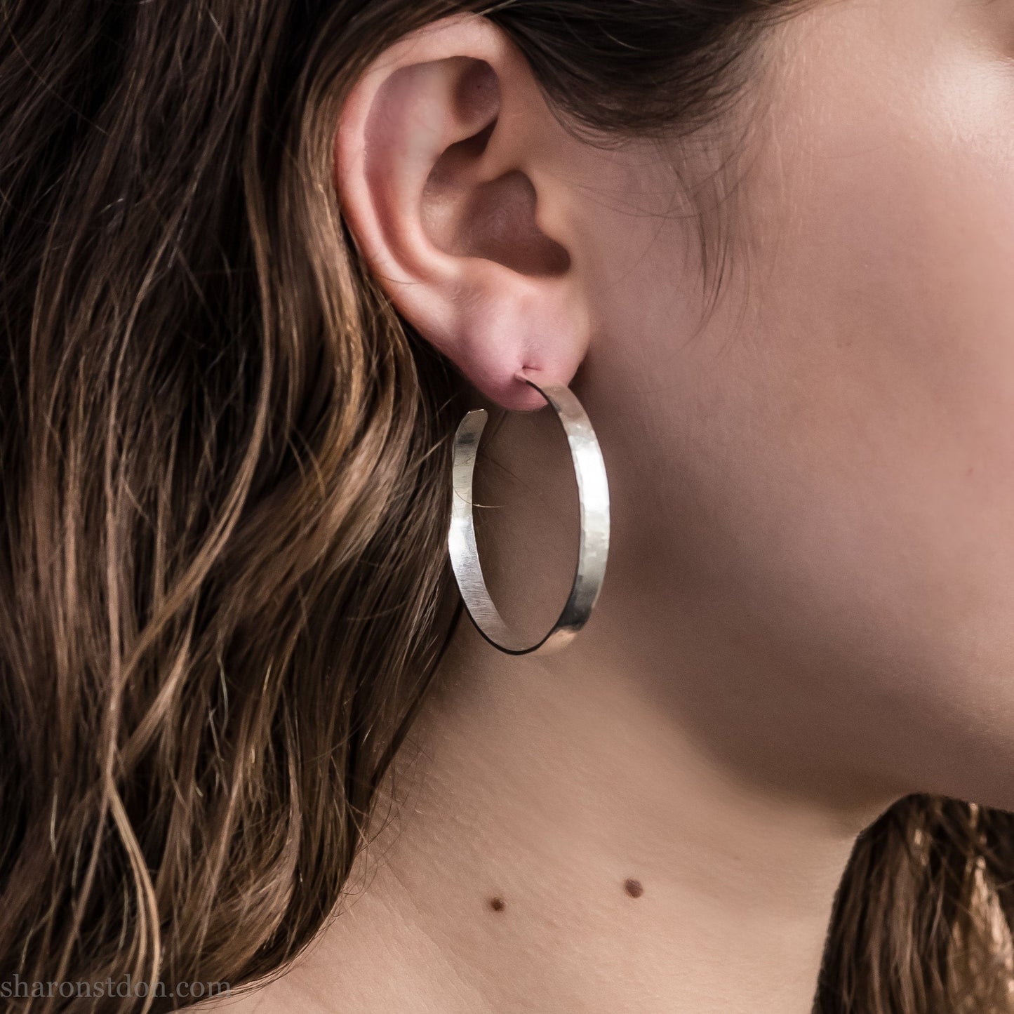 Solid 925 sterling silver hoop earrings. 40mm diameter, 5mm wide, .75 thick. Hammered texture, silver posts and backs. Handmade in USA by Sharon Saint Don.