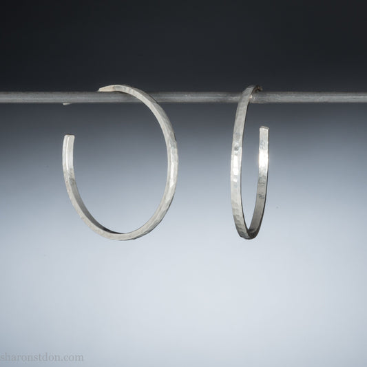 Handmade solid 925 sterling silver hoop earrings. 30mm diameter, 2mm wide, 1.5 thick. Silver posts and backs. Hammered by Sharon SaintDon in North America.