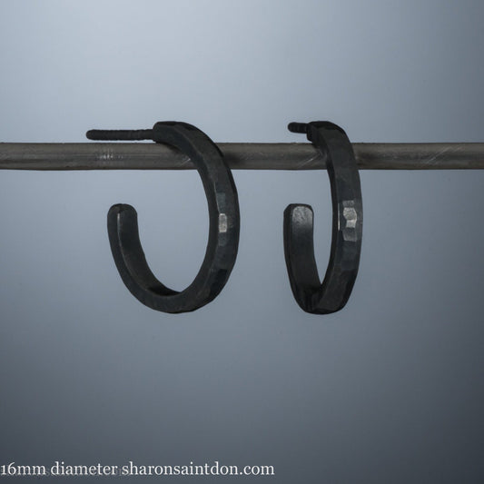 16mm x 2mm 925 sterling silver hoop earrings for men, handmade in North America by Sharon SaintDon. Oxidized black silver, small, round with hammered texture.