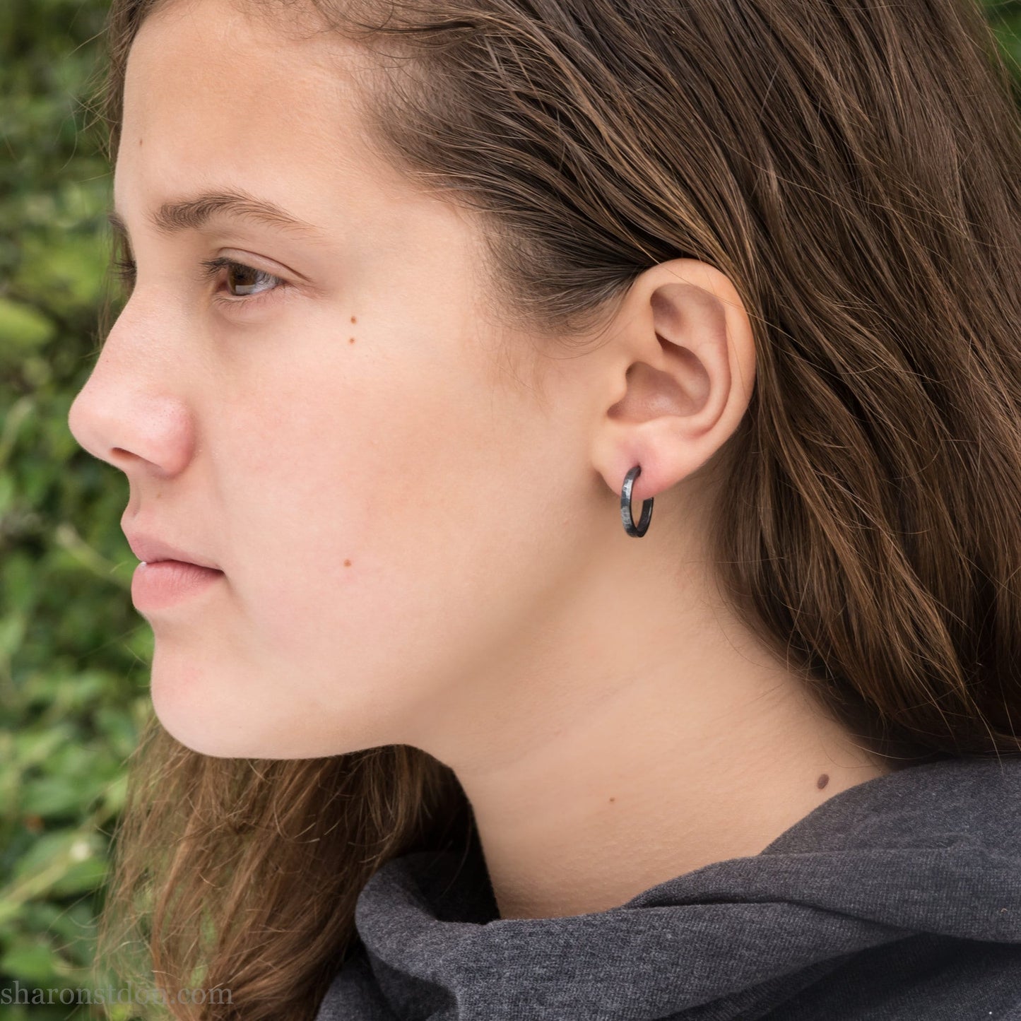 16mm x 2mm 925 sterling silver hoop earrings for men, handmade in North America by Sharon SaintDon. Oxidized black silver, small, round with hammered texture.