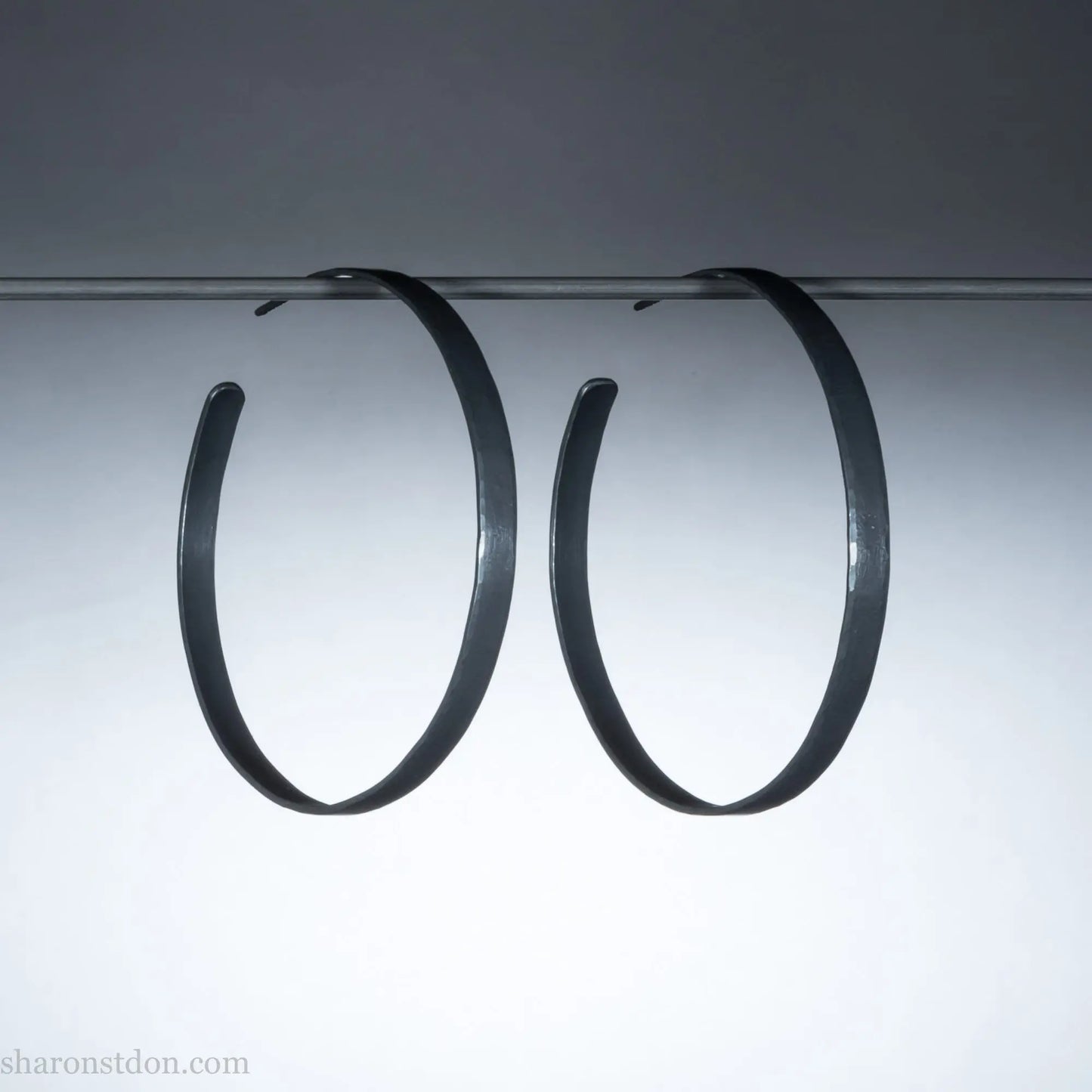 Handmade 925 sterling silver hoop earrings for women. 55mm diameter, 5mm wide, Oxidized black, large hoops for daily wear. Minimalist, comfortable, lightweight with a hammered, texture.