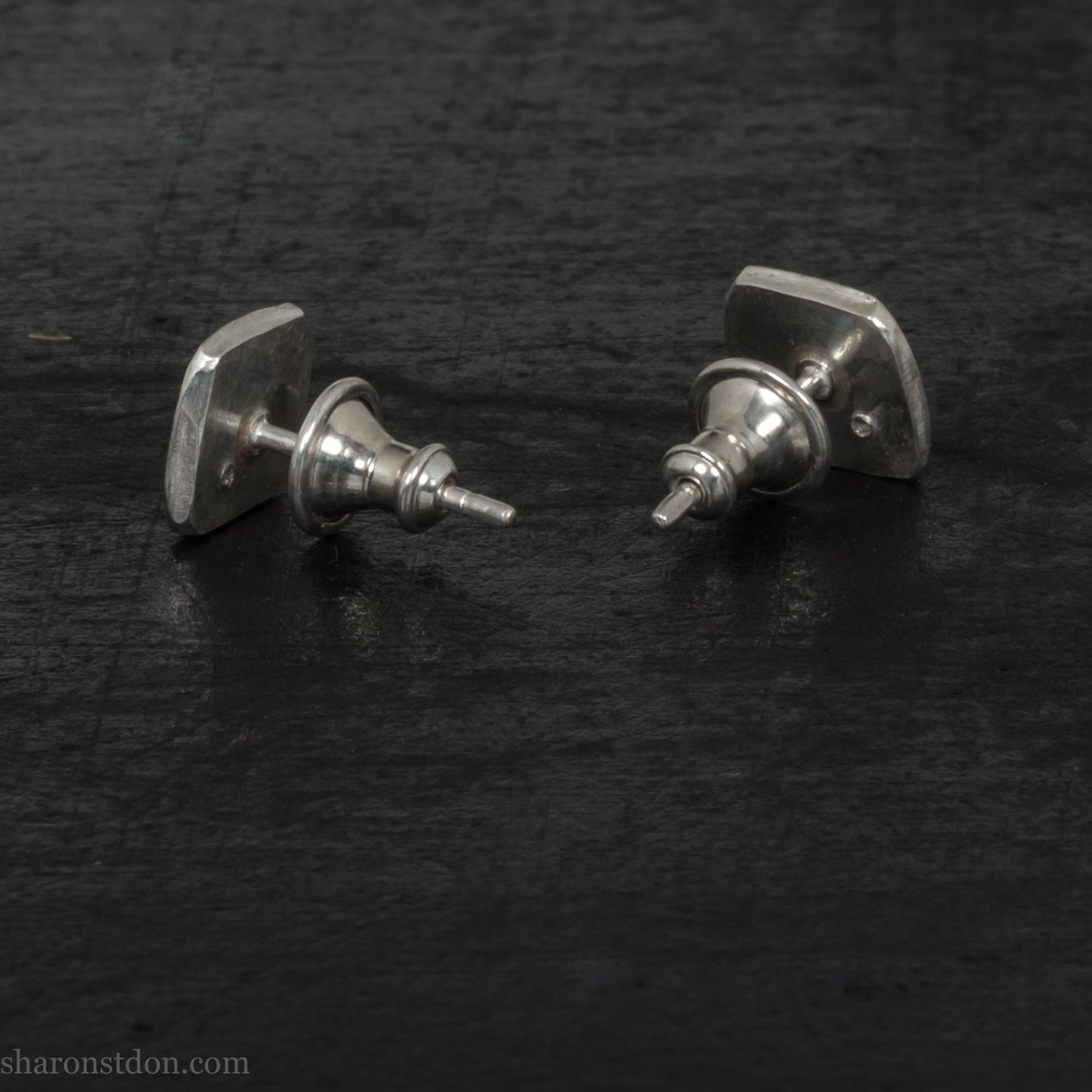 7mm x 7mm Handmade 925 sterling silver stud earrings with black spinel gemstone in the corner. Shiny, small square stud earrings made by Sharon SaintDon in North America.