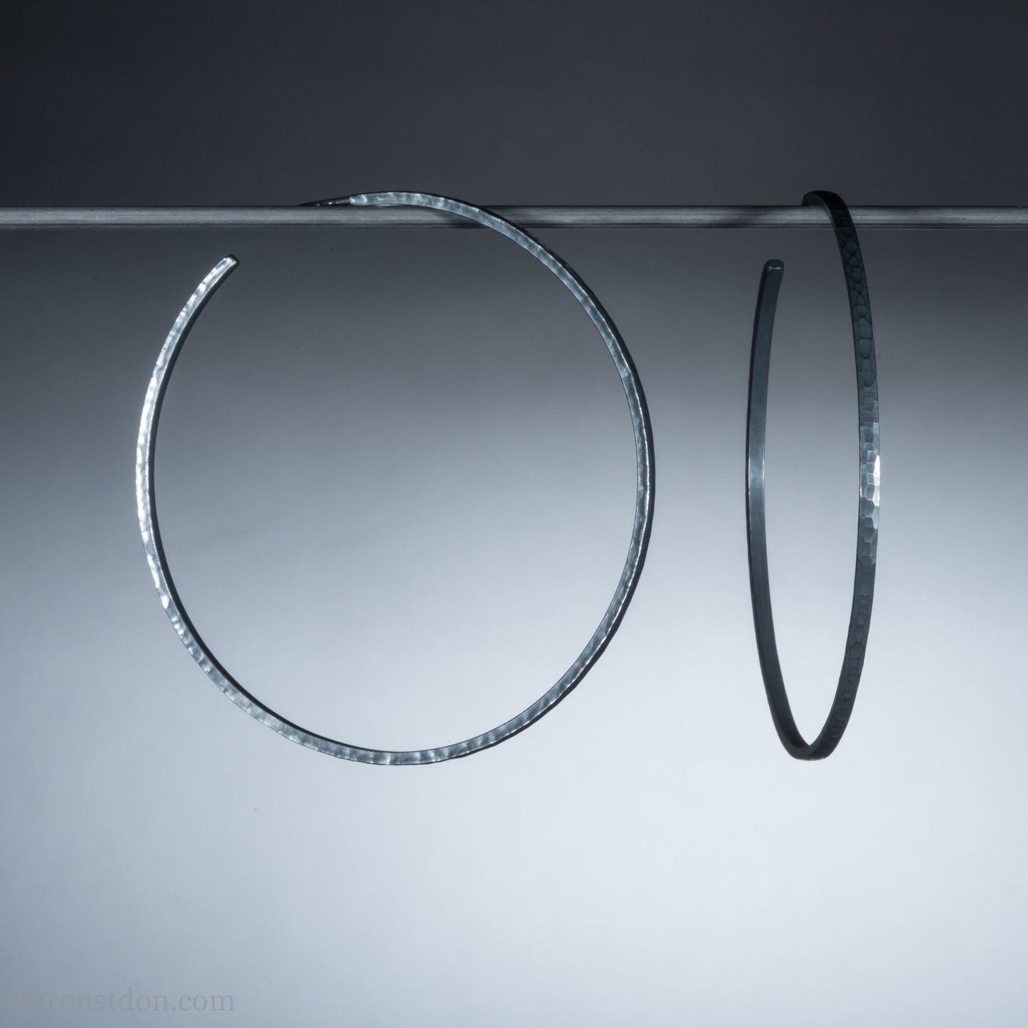 Handmade 925 sterling silver hoop earrings for women. 55mm diameter, 2mm wide, oxidized black, large hoops for daily wear. Minimalist, comfortable, lightweight with a hammered, texture.