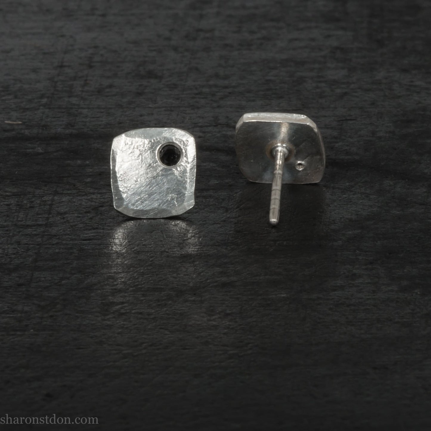 7mm x 7mm Handmade 925 sterling silver stud earrings with black spinel gemstone in the corner. Shiny, small square stud earrings made by Sharon SaintDon in North America.