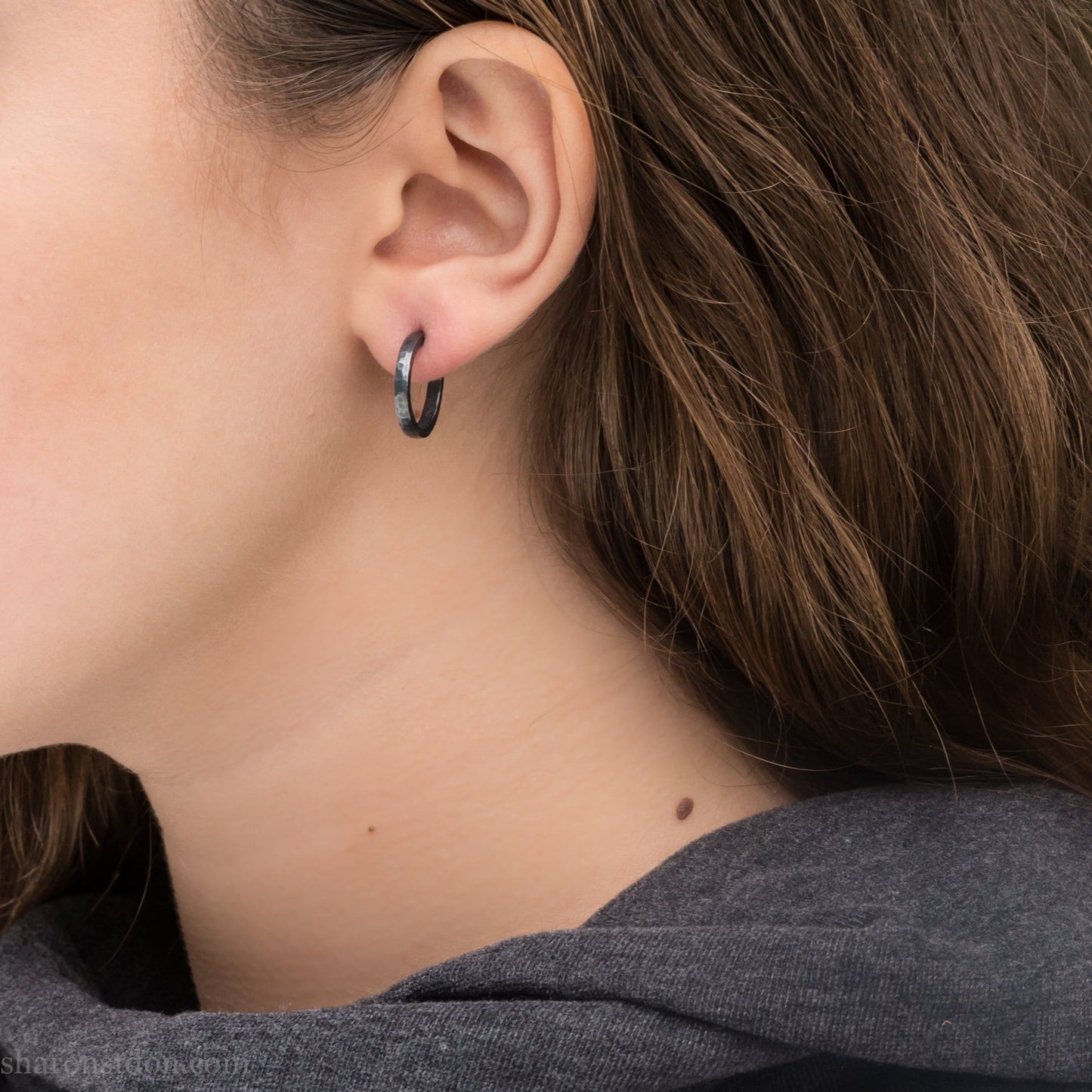 16mm x 2mm 925 sterling silver hoop earrings for men, handmade in North America by Sharon SaintDon. Oxidized black silver, small, round with hammered texture.