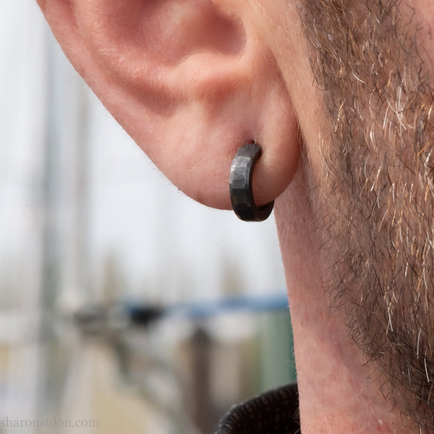 12mm x 3mm small sterling silver hoop earrings, Handmade in North America by Sharon SaintDon. Oxidized black, hammered texture, solid silver with silver posts and backs for men or women, unisex.