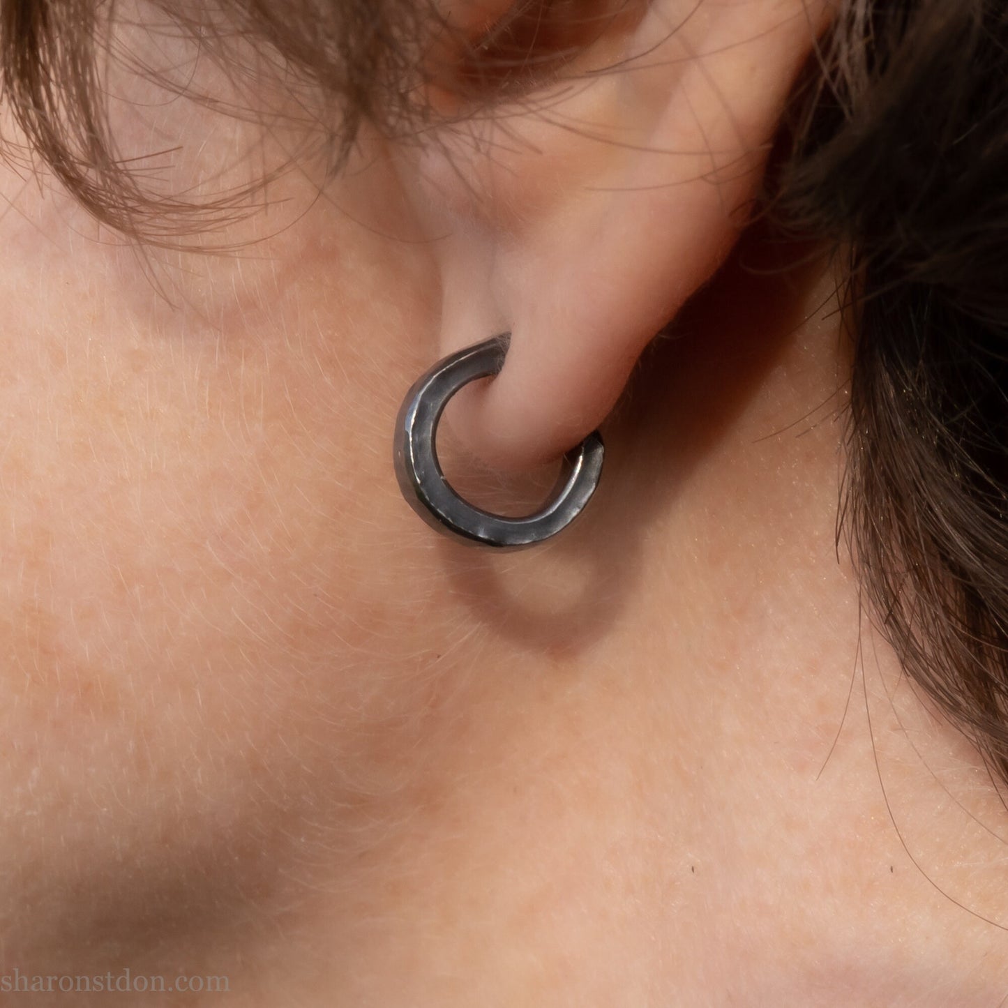 12mm x 3mm small sterling silver hoop earrings, Handmade in North America by Sharon SaintDon. Oxidized black, hammered texture, solid silver with silver posts and backs for men or women, unisex.