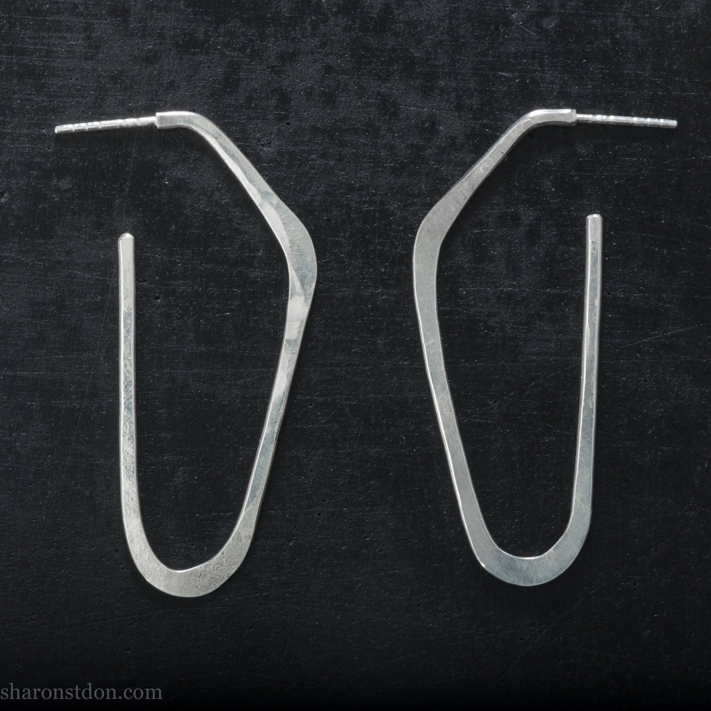 925 sterling silver hoop earrings handmade in North America. Long angular shape with hammered texture.