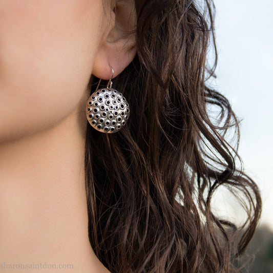 Handmade 925 sterling silver earrings for women. Round disc earrings with perforated holes made by Sharon SaintDon in North America. 25mm diameter.