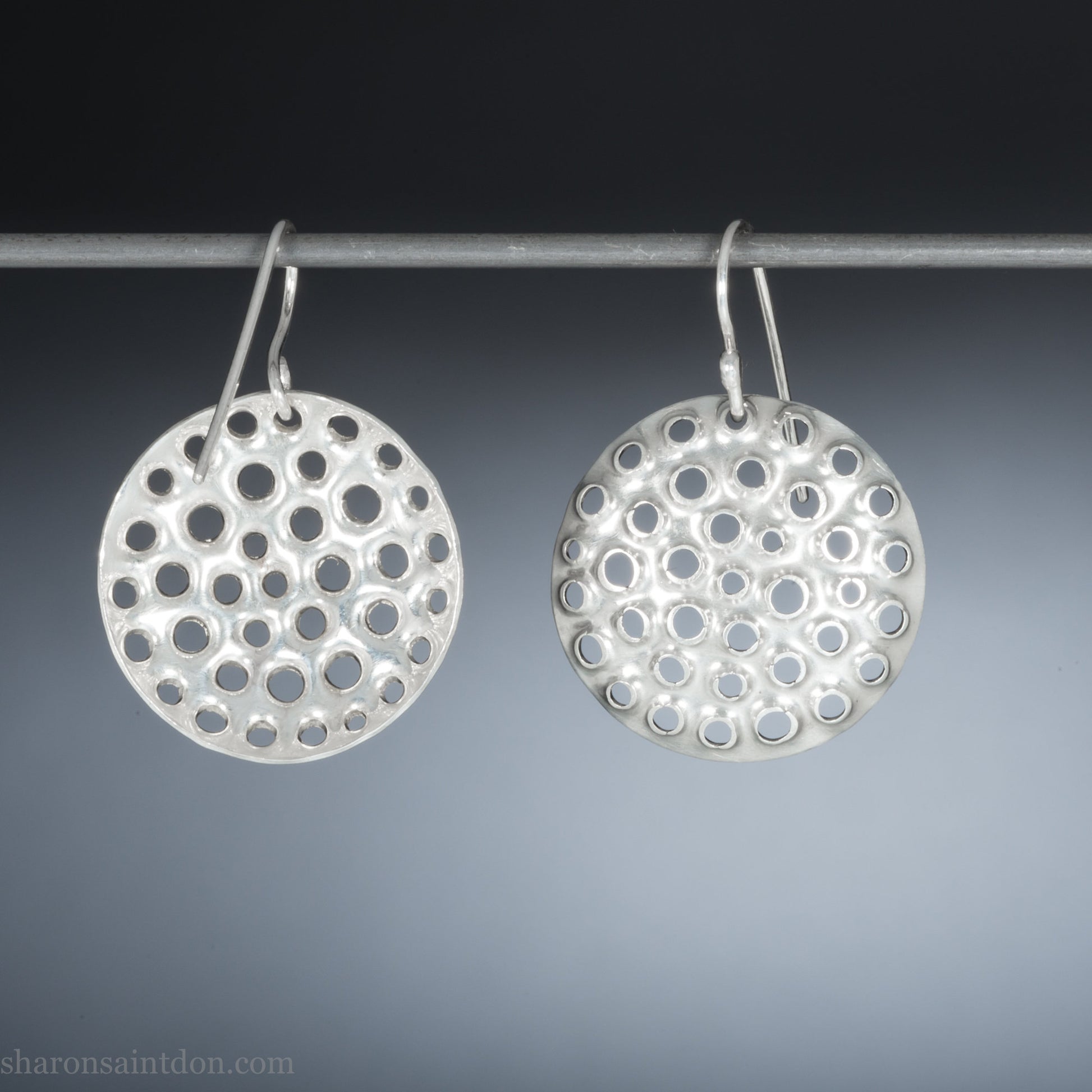 Handmade 925 sterling silver earrings for women. Round disc earrings with perforated holes made by Sharon SaintDon in North America. 25mm diameter.