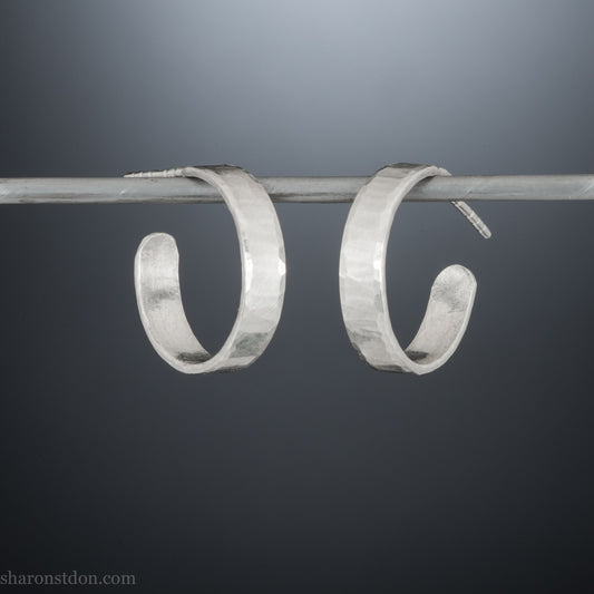 925 sterling silver hoop earrings handmade in North America by Sharon SaintDon. 18mm diameter round, 4mm wide, hammered texture, matte, brushed finish and silver posts and backs.